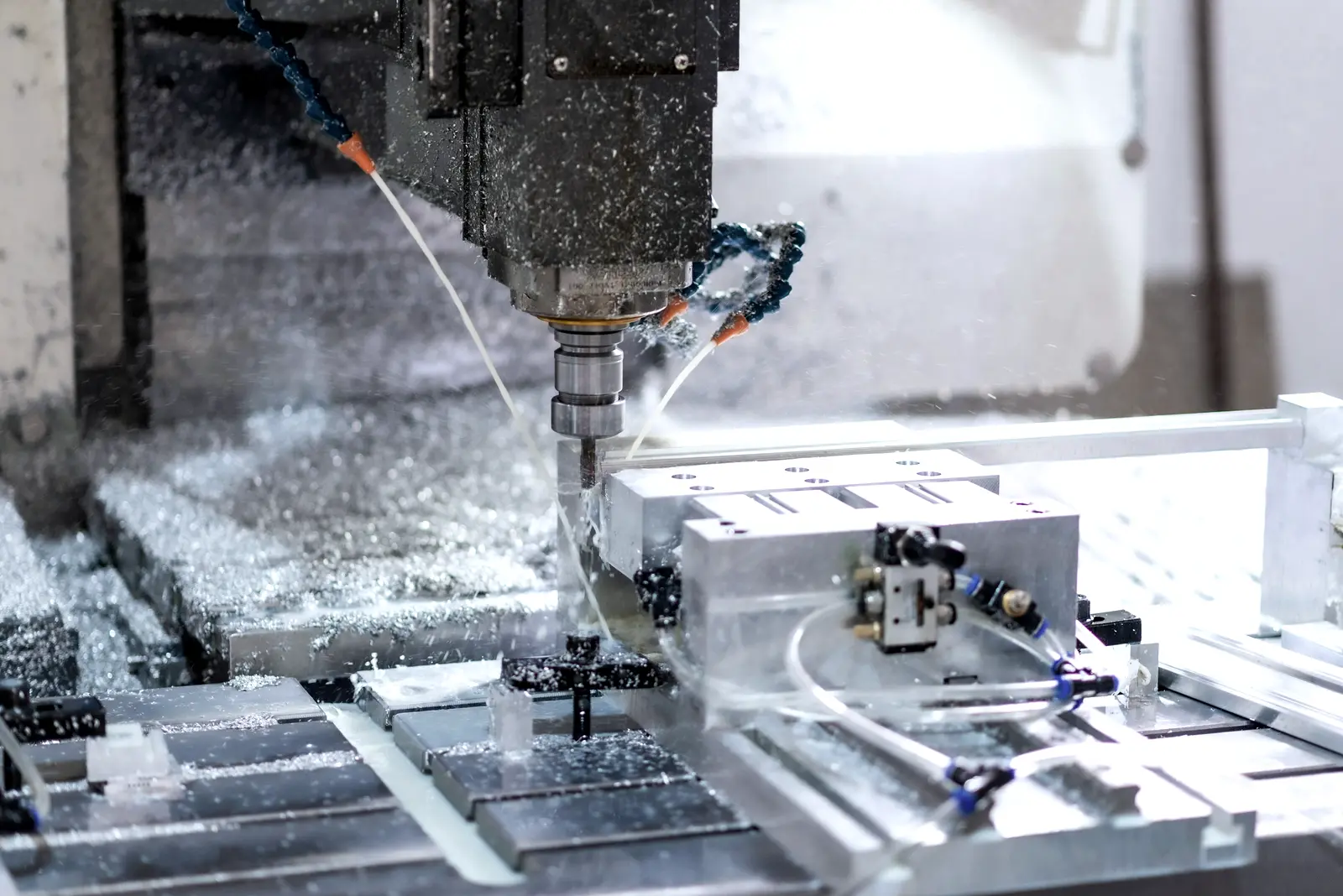 Aluminium block being milled under coolant in a machining centre