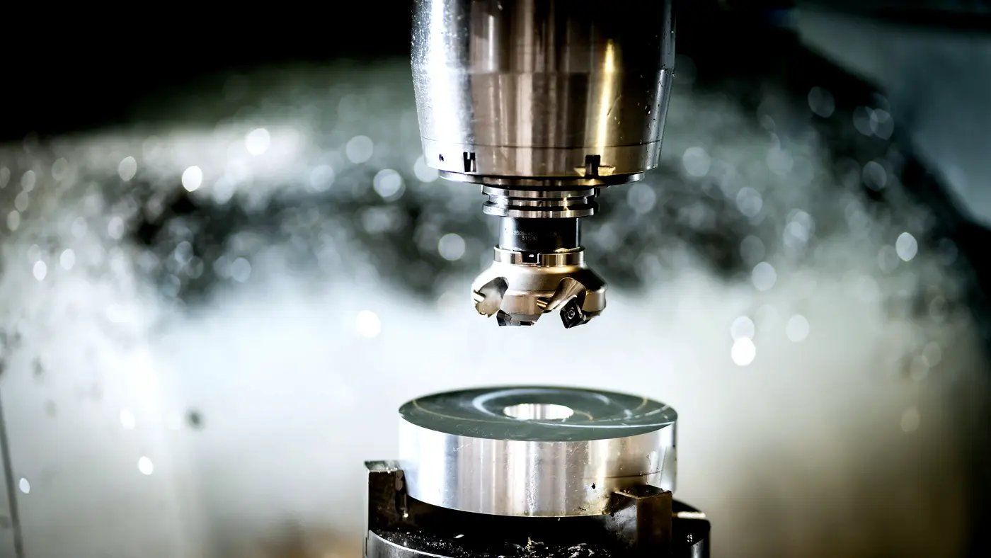 Face mill above a turned steel part on a machining centre
